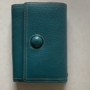 TUSK tri-fold wallet.  Teal blue color, red lining, leather.